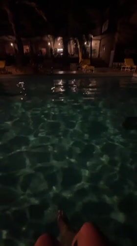 Person enjoys quiet poolside moment in Tozeur, Tunisia
