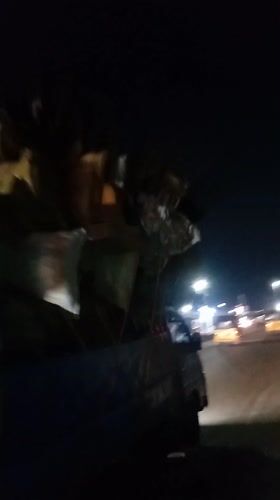 Evening street vendors and transport activity documented in Ikeja