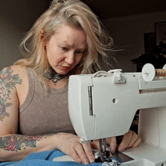 Woman tailors denim jacket with Chihuahua companion in Saint Petersburg