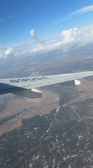 Passenger captures aerial view over snow-patched Russian countryside