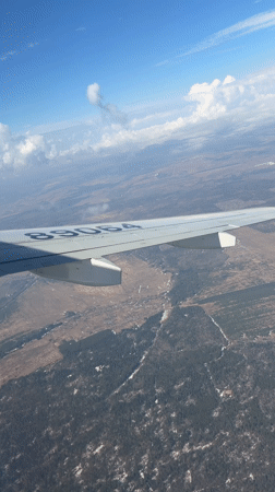 Passenger captures aerial view over snow-patched Russian countryside