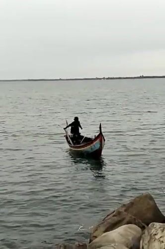 Colorful wooden boat rowing off the Lhokseumawe coast
