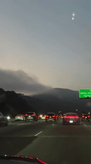 Rush hour traffic flows on I-405 freeway at dusk