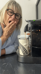 Woman yawns while making early morning coffee in Chambœuf