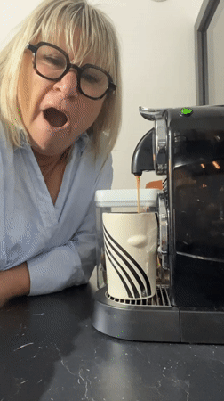 Woman yawns while making early morning coffee in Chambœuf