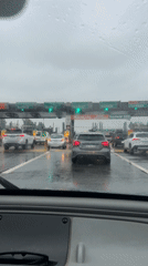 Motorist waits at toll booth during rain in Argentina