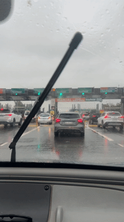 Motorist waits at toll booth during rain in Argentina