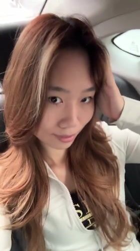 Woman takes selfie in car backseat in Liangjiang