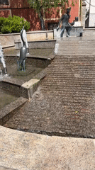 Dog drinks from decorative fountain in Burgas park