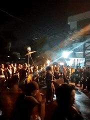 Traditional nighttime street procession with torches and ceremonial dress, Surakarta