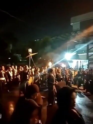 Traditional nighttime street procession with torches and ceremonial dress, Surakarta