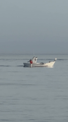 Small white boat cruising calm waters off Estepona