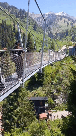 Morning visitors enjoy suspension bridge recreation near Almaty mountains