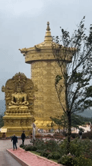 Ornate golden prayer wheel at a Buddhist site in Bookabang