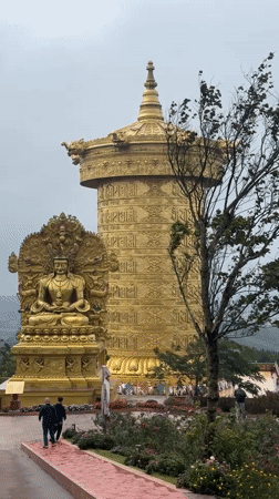Ornate golden prayer wheel at a Buddhist site in Bookabang