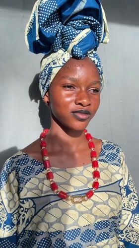 Woman poses in traditional Nigerian dress in Badagry