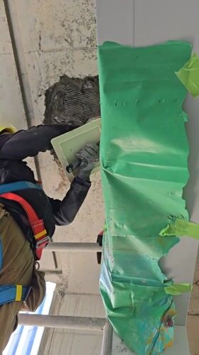 Construction worker repairs concrete walls, ceiling in Ramat Hasharon