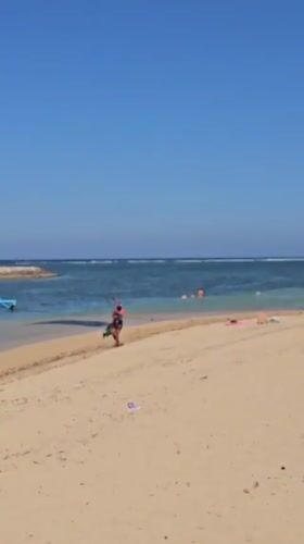 Lazy beach morning in Bali with coconuts and kiteboarding