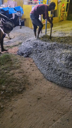 Concrete being poured and spread at a Tamando construction site