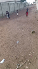 Children play games on dirt road in Katcha residential area