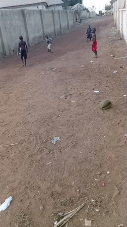 Children play games on dirt road in Katcha residential area