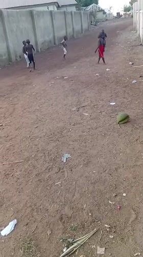 Children play games on dirt road in Katcha residential area