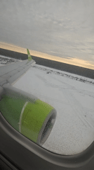Icy aircraft taxis on snowy Russian runway