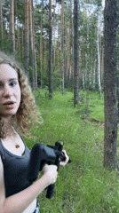 Woman photographed with rifle in Russian forest clearing