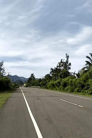 Tropical road documented in Meunasahmesjid under overcast skies