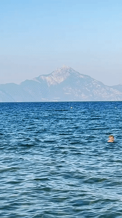A calm beach afternoon in Toroni, waves erasing a name in the sand.