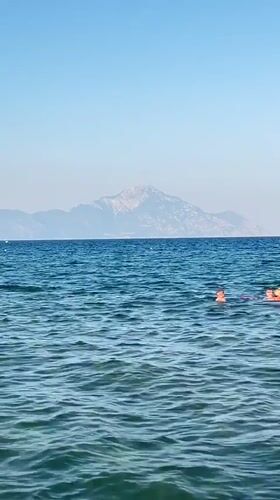 A calm beach afternoon in Toroni, waves erasing a name in the sand.