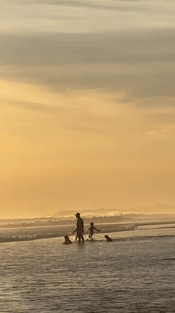 Families enjoy golden hour beach time in North Kuta