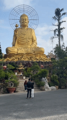 Golden Buddha statue with metal halo observed in Đà Lạt