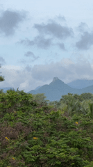Overcast skies and green hills in Ettimadai, India
