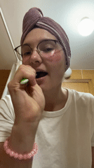 Woman brushes teeth with eye patches in Budva bathroom