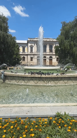 Ruse city center: opera house, ornate facades, and a pigeon fountain