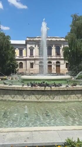 Ruse city center: opera house, ornate facades, and a pigeon fountain