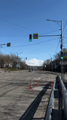 Normal traffic flows through Petropavlovsk-Kamchatsky streets beneath snowy peaks