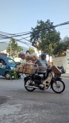 Late night street food vendors and pedestrians in Quy Nhon