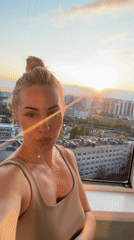 Woman films sunset selfies, urban scenes in Russian city