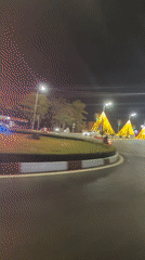 Decorated street lights illuminate nighttime traffic in Vietnamese ward