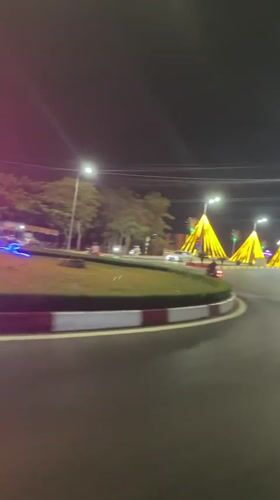 Decorated street lights illuminate nighttime traffic in Vietnamese ward
