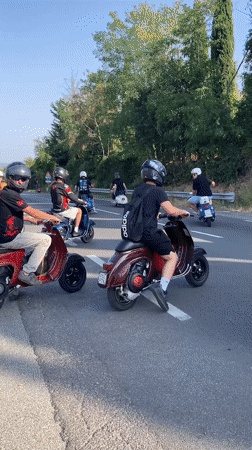 Vespa group ride through sun-drenched San Quirico d'Orcia