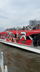 Tourist boat passes ICONSIAM mall on Bangkok's Chao Phraya River