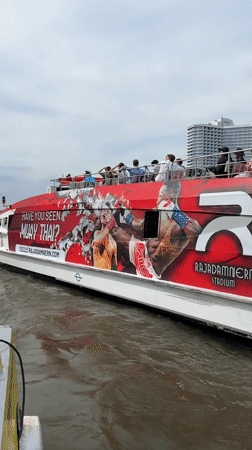 Tourist boat passes ICONSIAM mall on Bangkok's Chao Phraya River