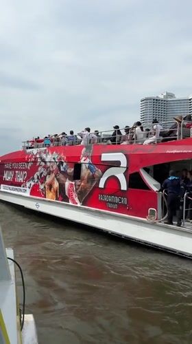 Tourist boat passes ICONSIAM mall on Bangkok's Chao Phraya River
