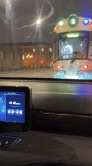 Tram stops at red light in Saint Petersburg night traffic