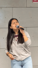 Woman performs with microphone in Barcelona indoor venue