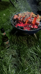 Late-night barbecue session captured with meat and vegetable skewers