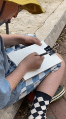Young artist sketches outdoors on Moscow walkway